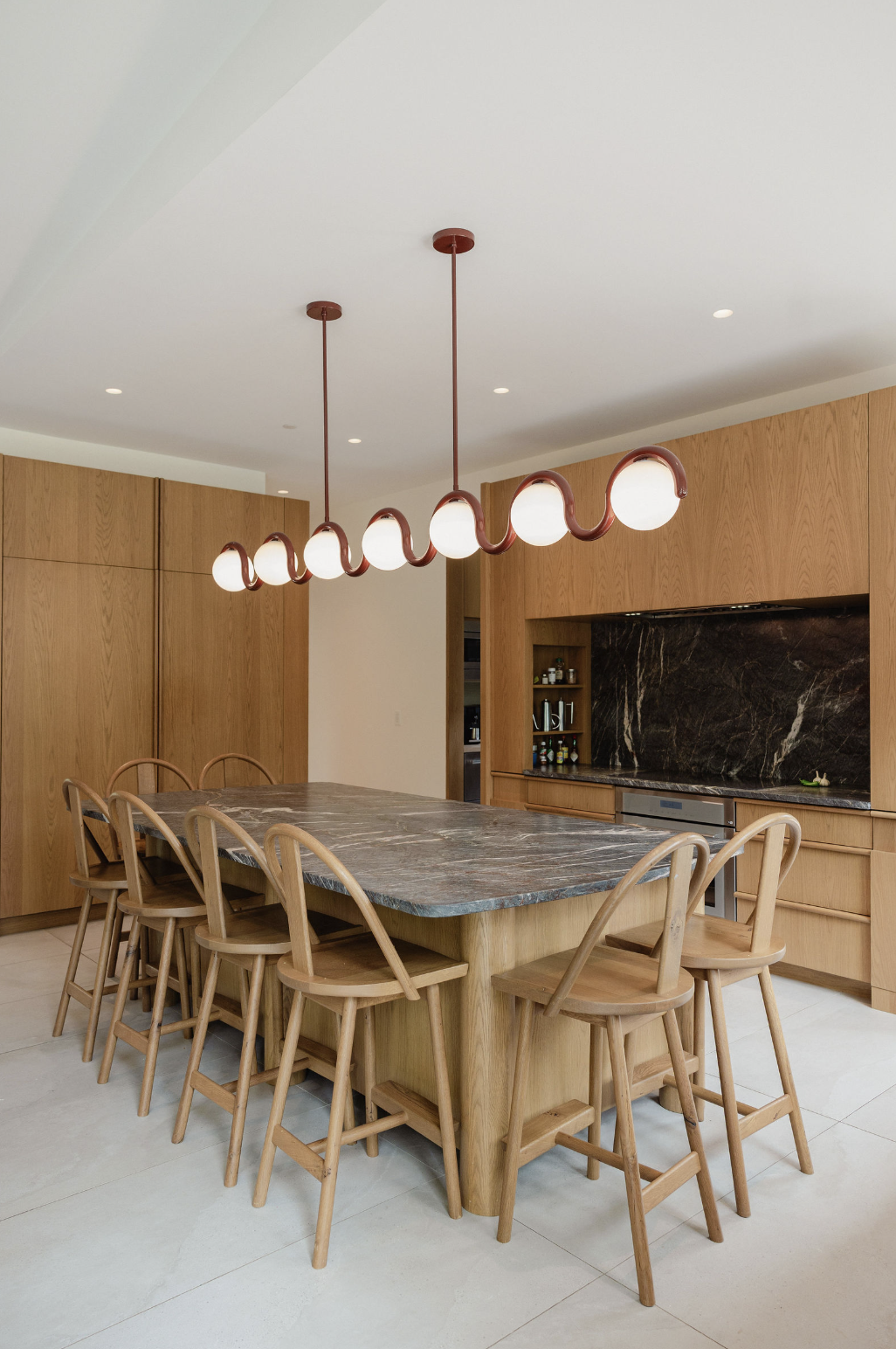 Wood high chairs around a kitchen island